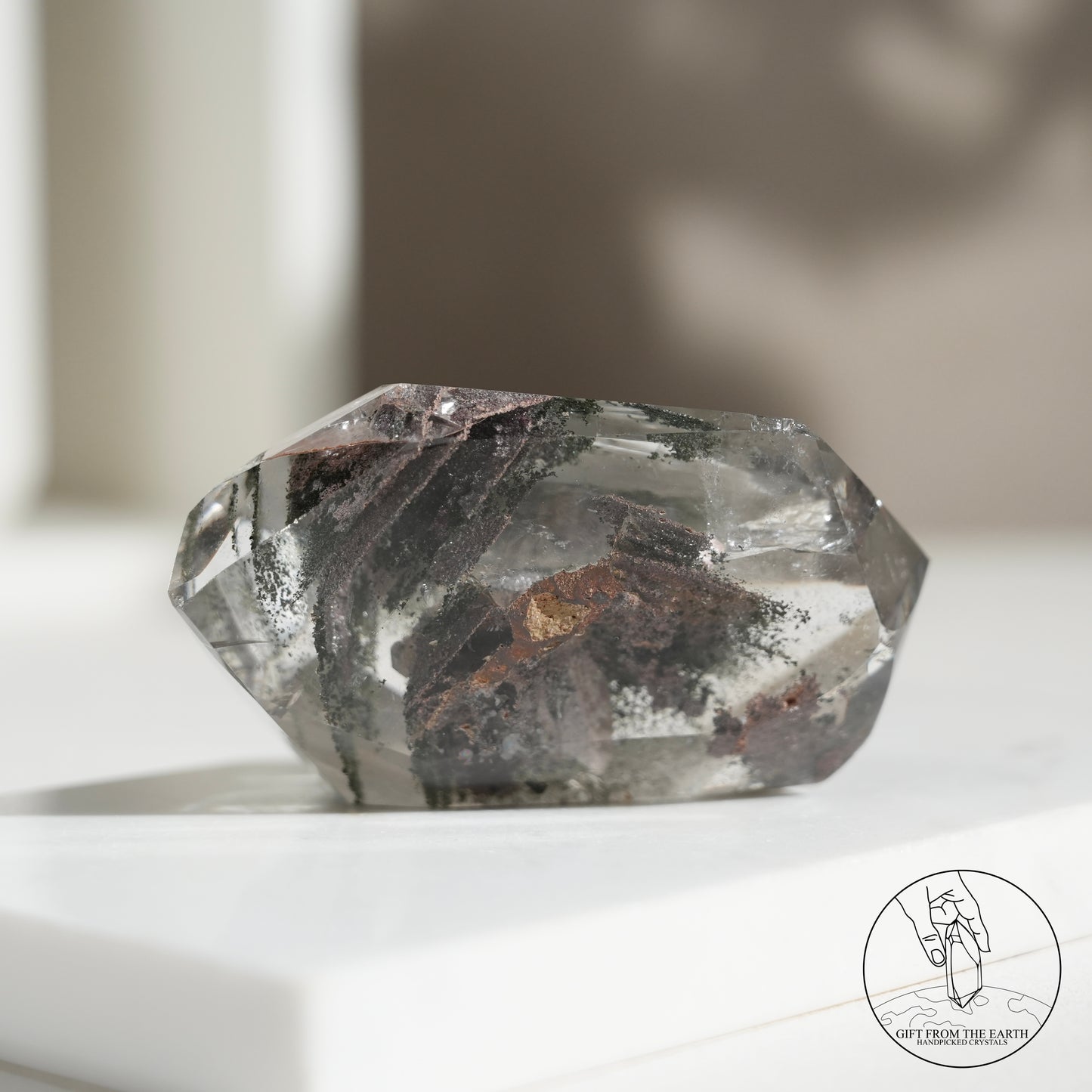 Half-polished multi-layered red-green phantom quartz point