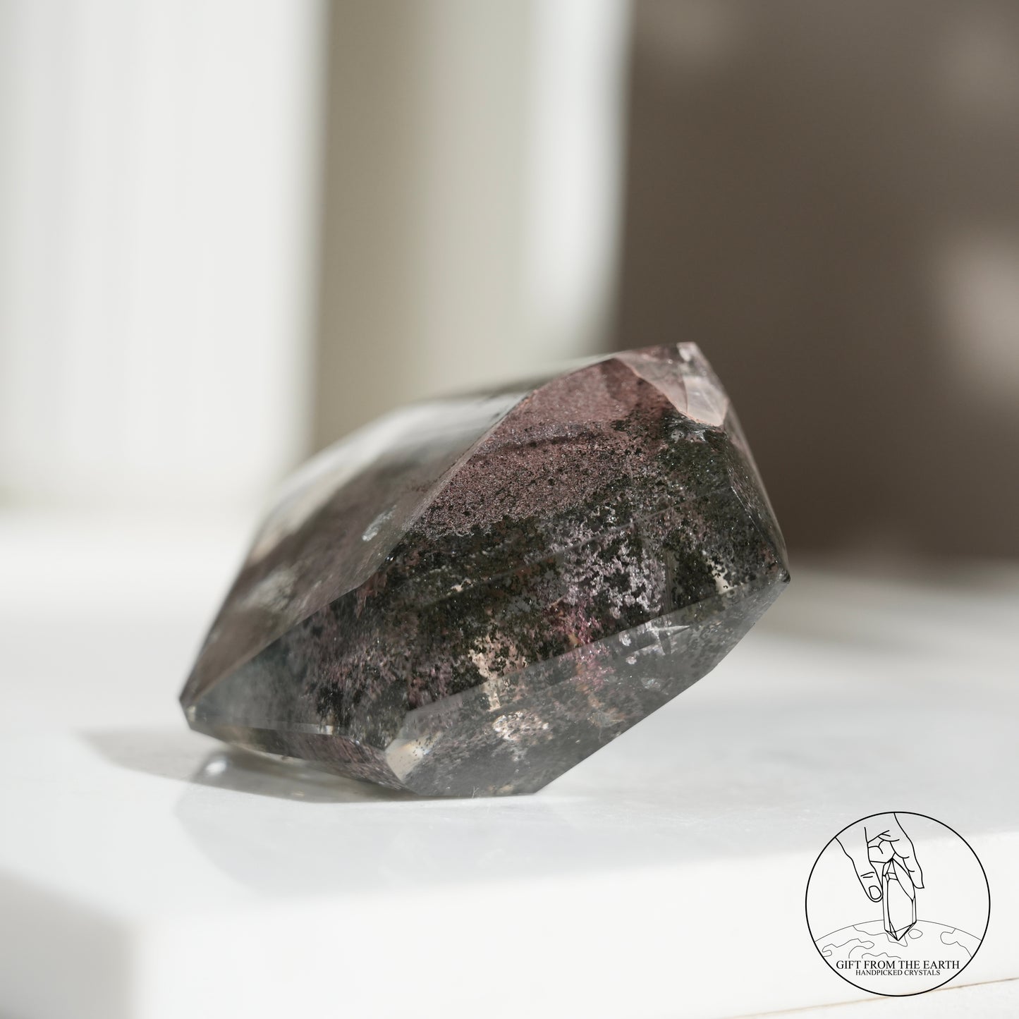 Half-polished multi-layered red-green phantom quartz point