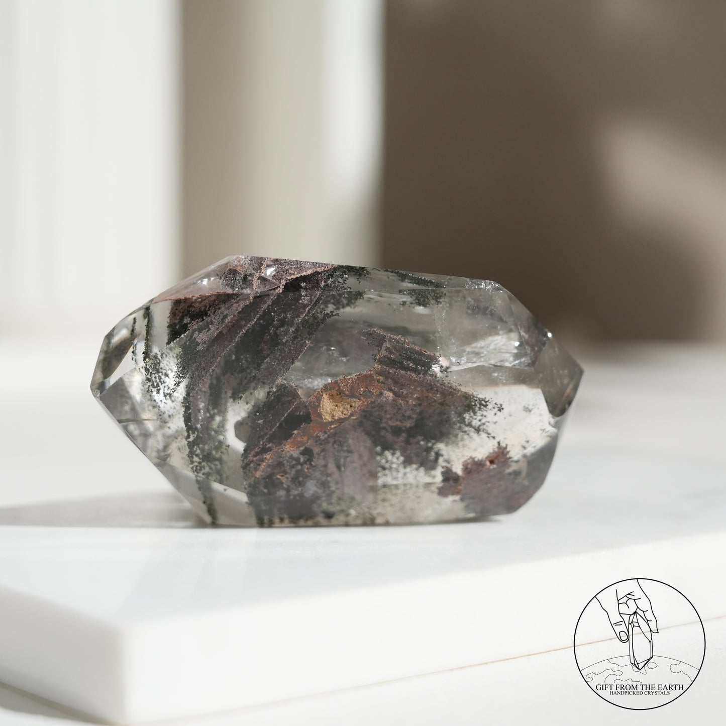 Half-polished multi-layered red-green phantom quartz point