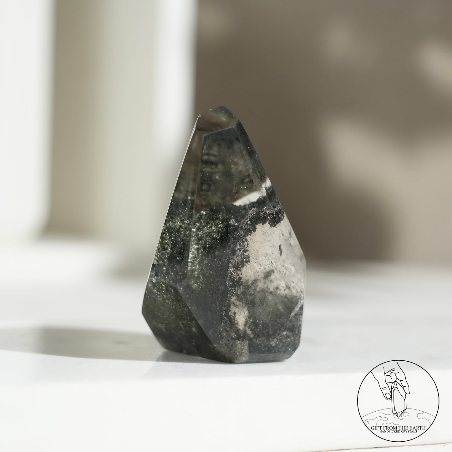 Half-polished multi-layered red-green phantom quartz point