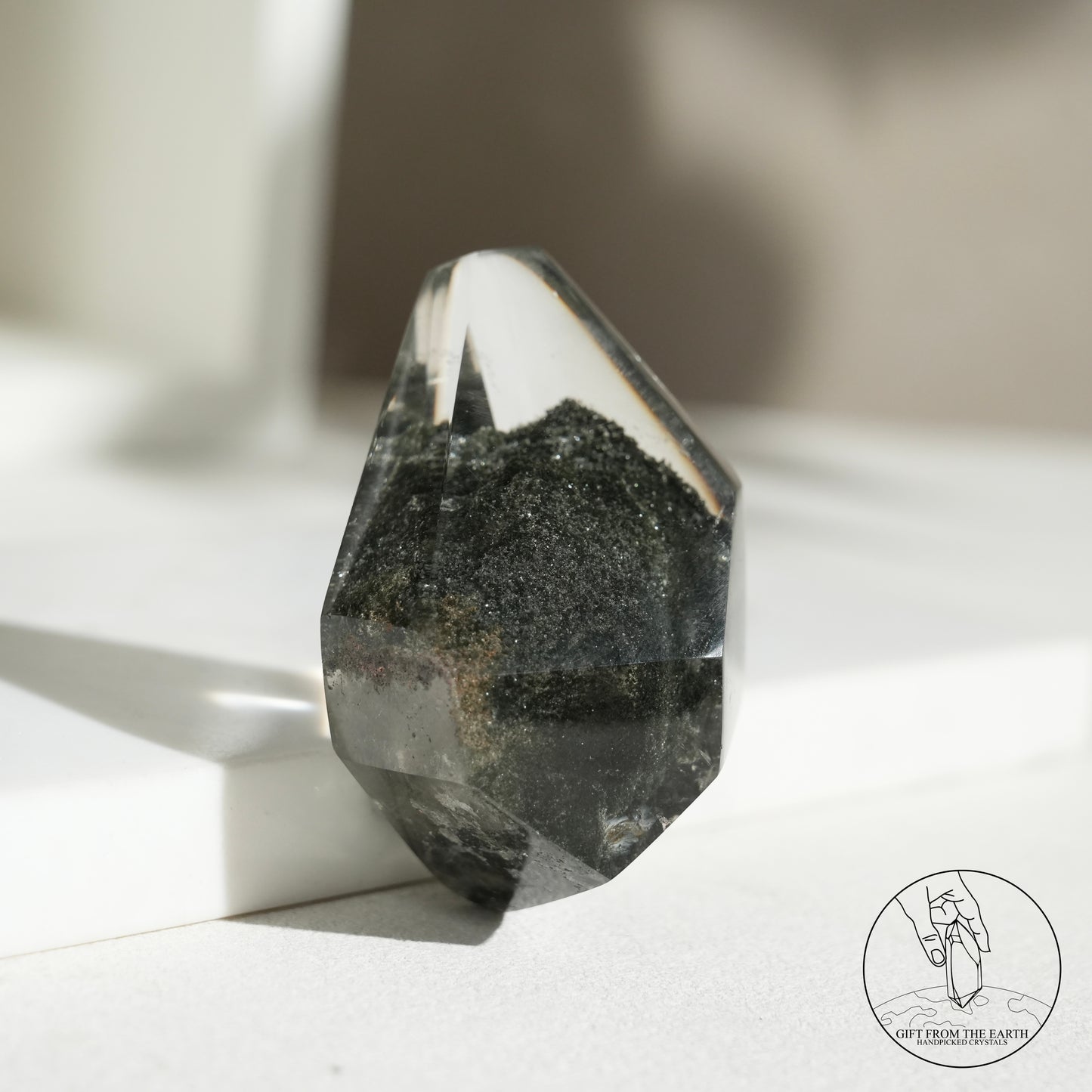 Half-polished multi-layered red-green phantom quartz point