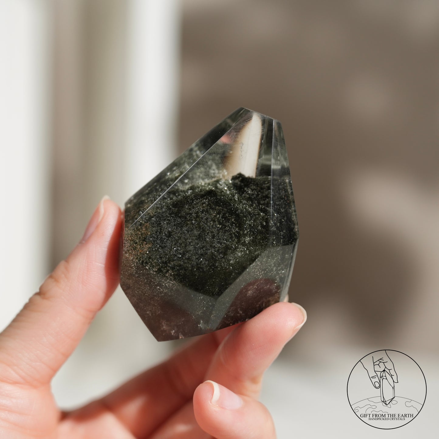 Half-polished multi-layered red-green phantom quartz point