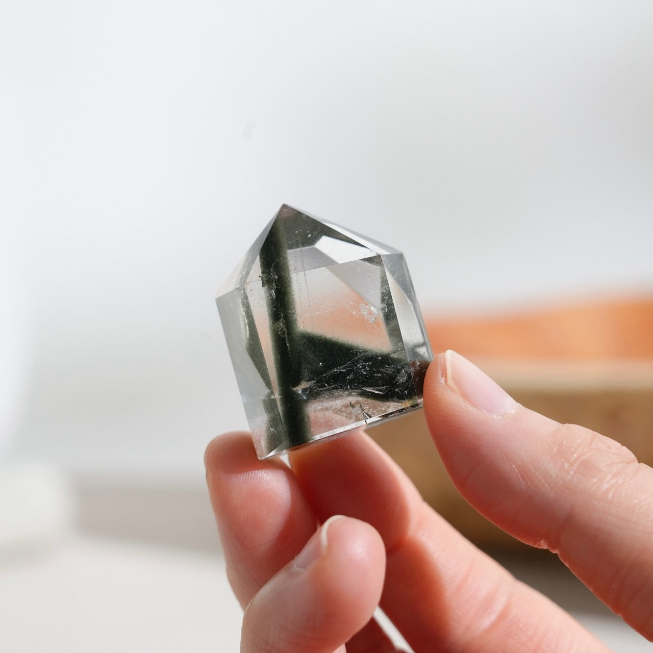 Half-polished multi-layered red-green phantom quartz point