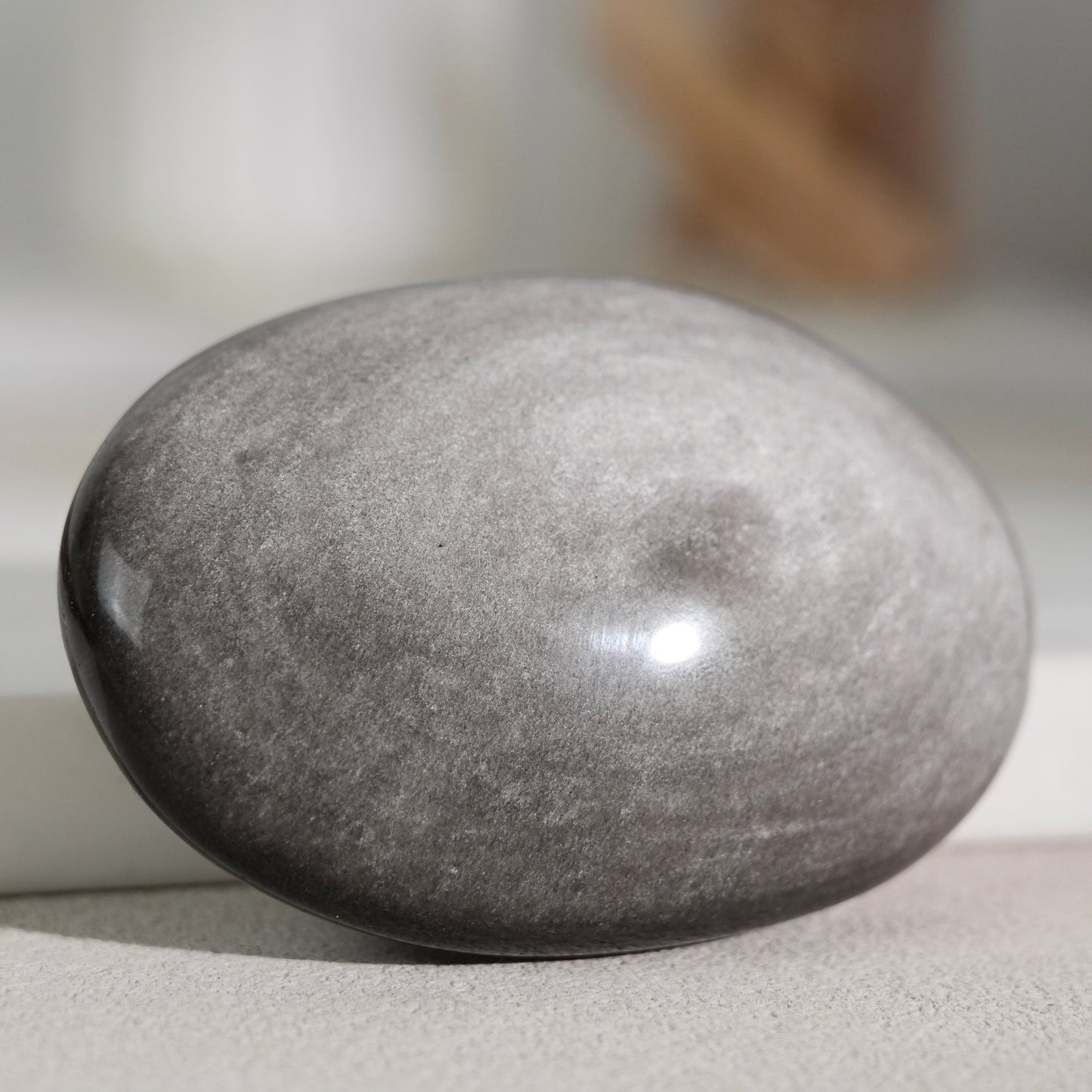Silver sheen obsidian palm stone