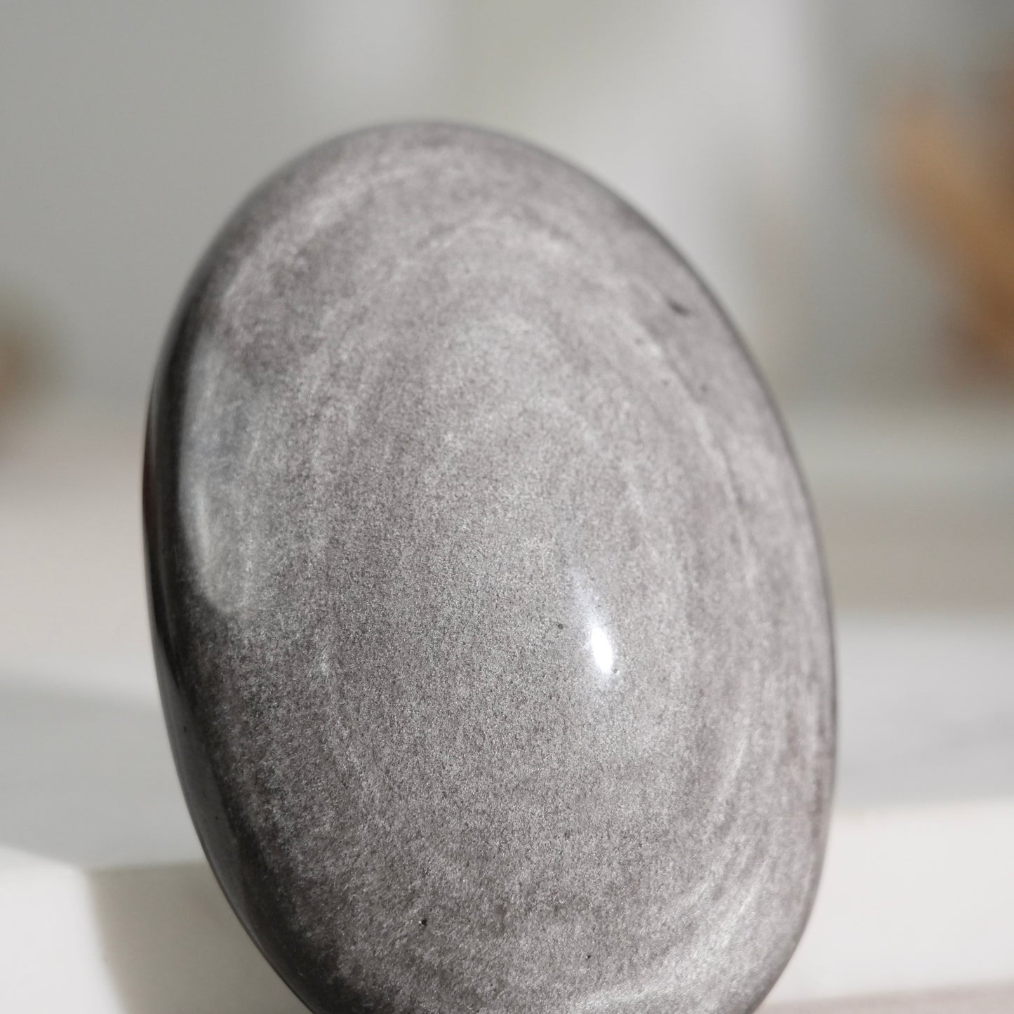 Silver sheen obsidian palm stone