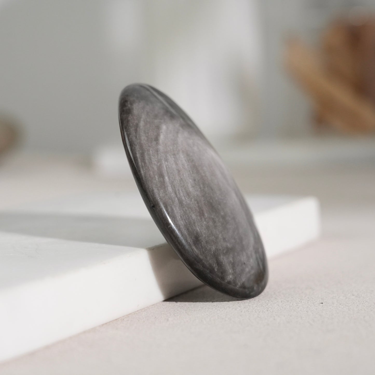Silver sheen obsidian palm stone