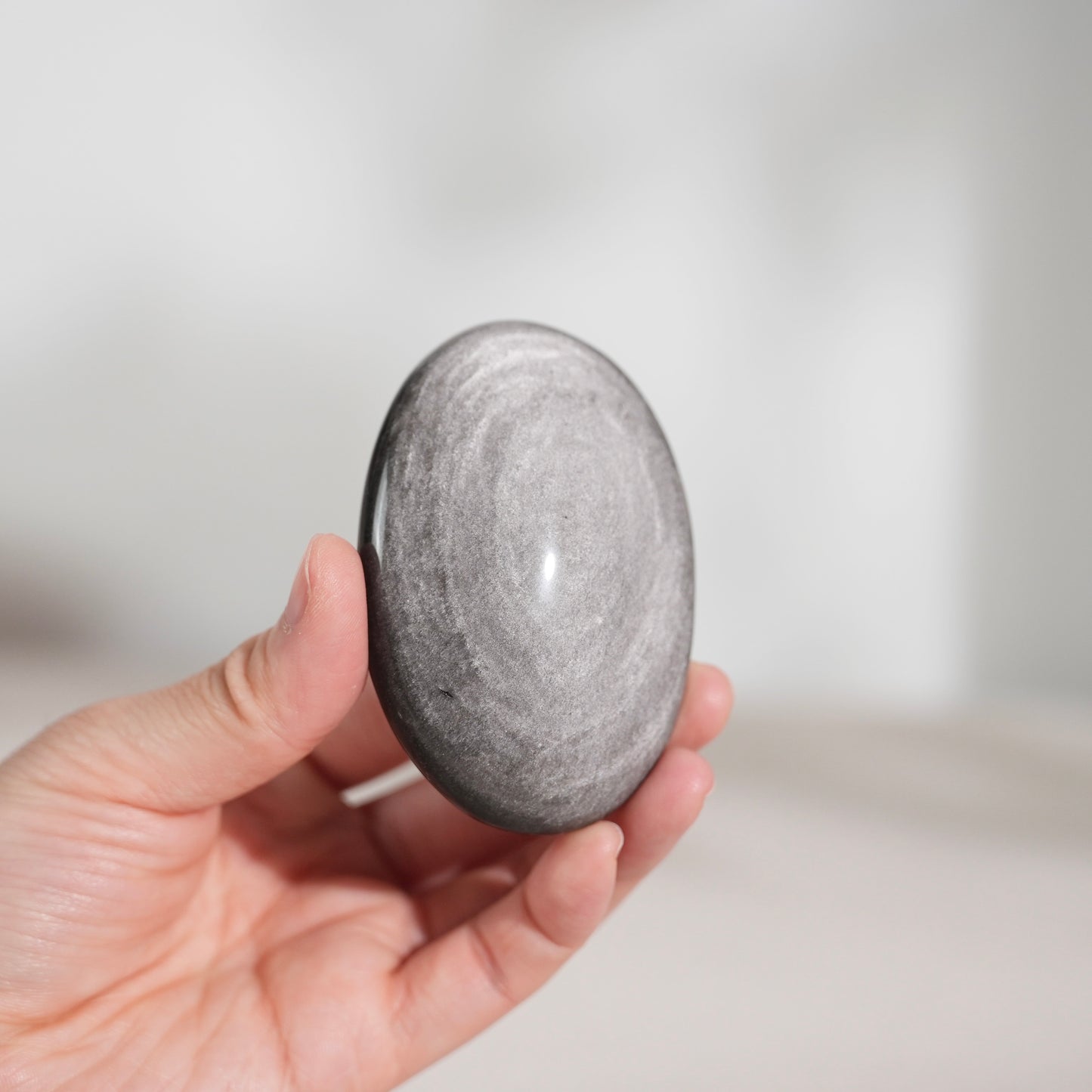 Silver sheen obsidian palm stone