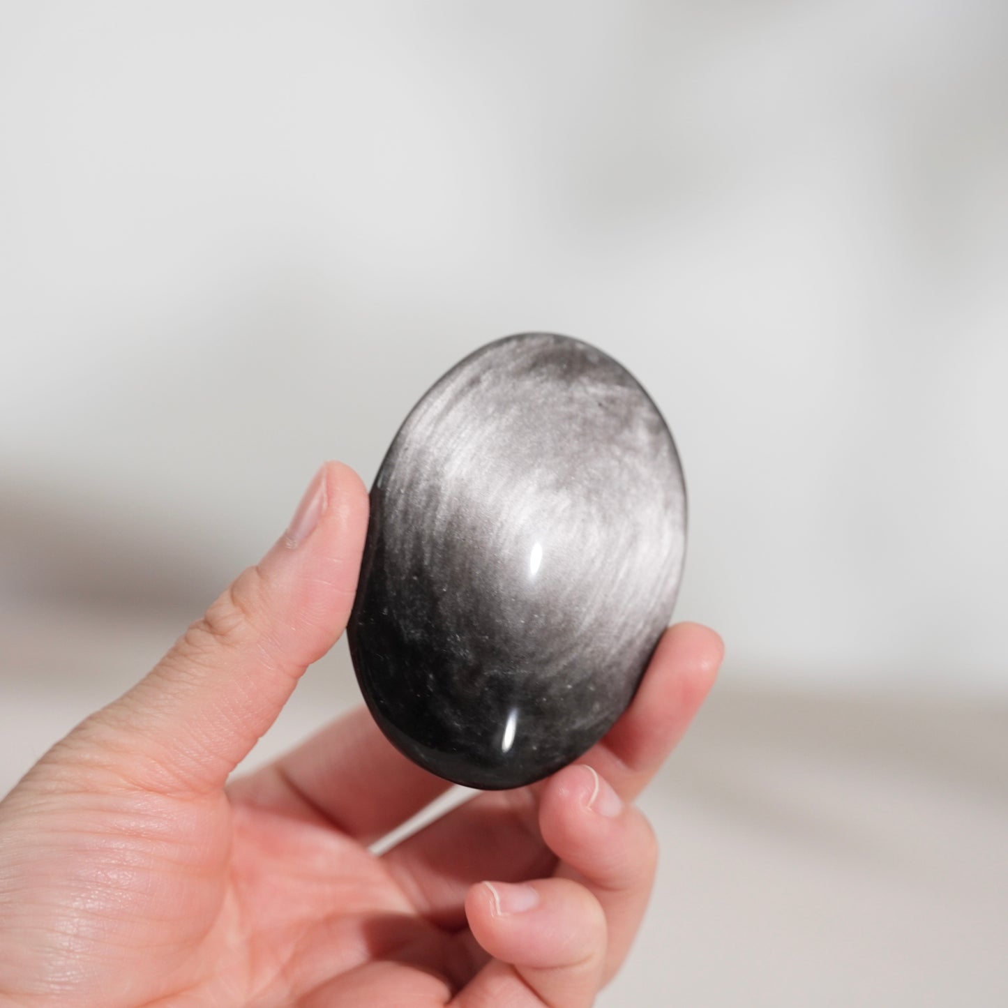 Silver sheen obsidian palm stone