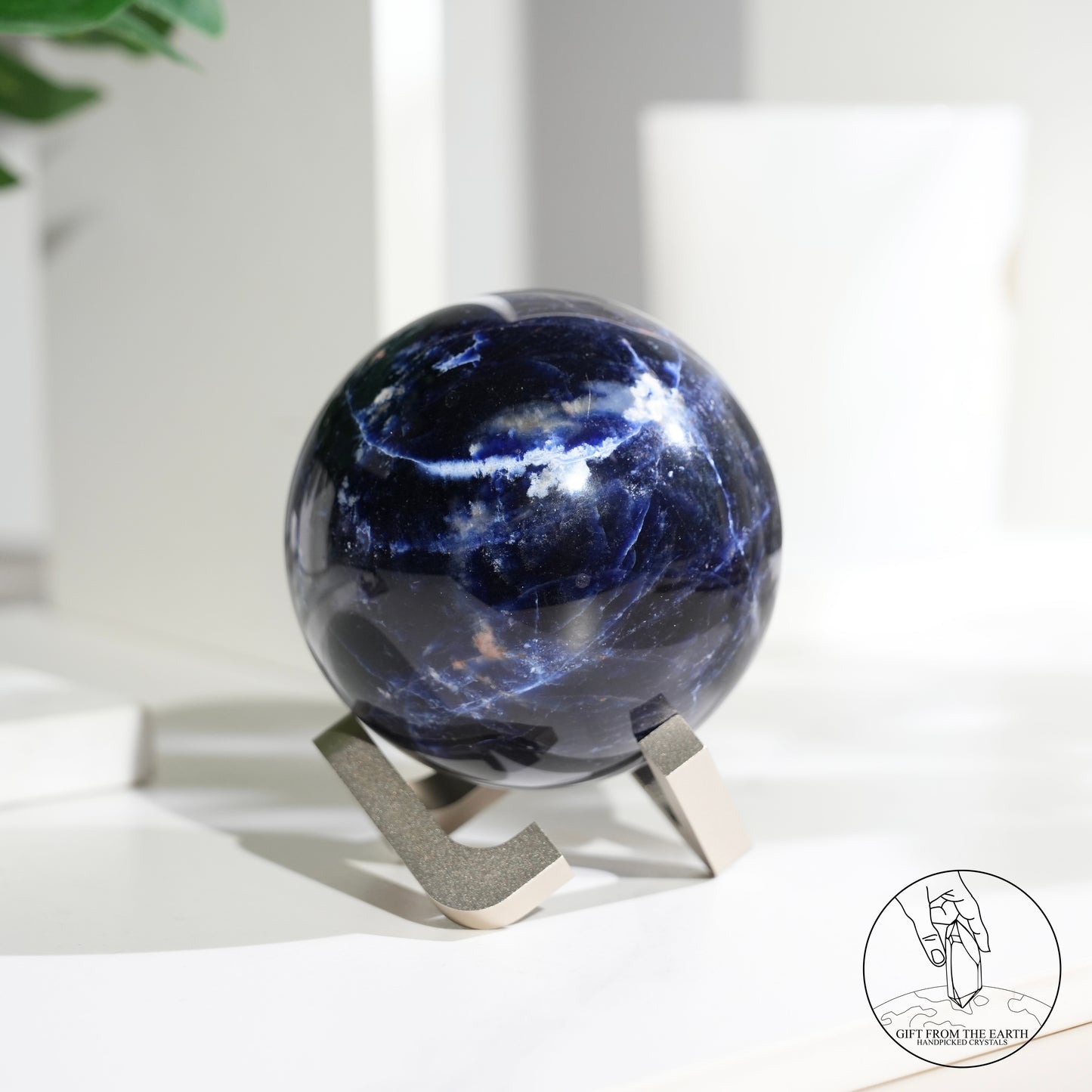 Larimar sphere with feldspar