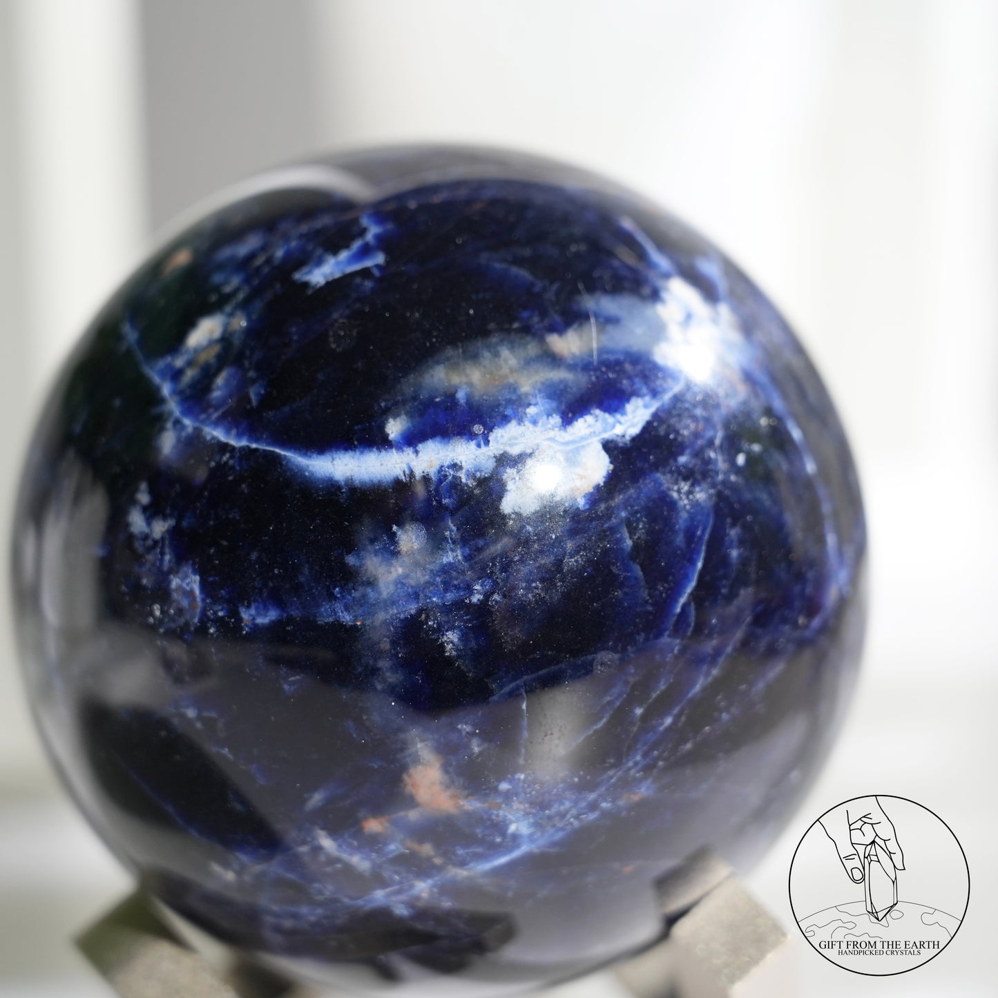 Larimar sphere with feldspar