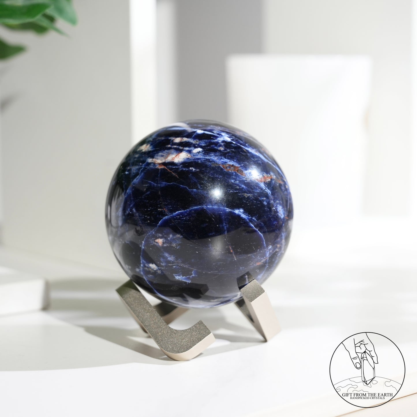 Larimar sphere with feldspar