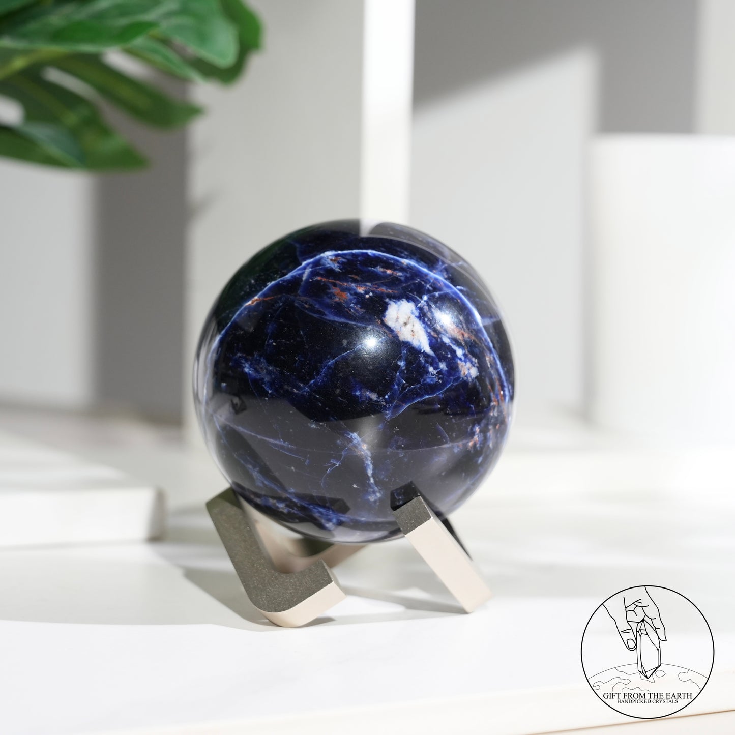 Larimar sphere with feldspar