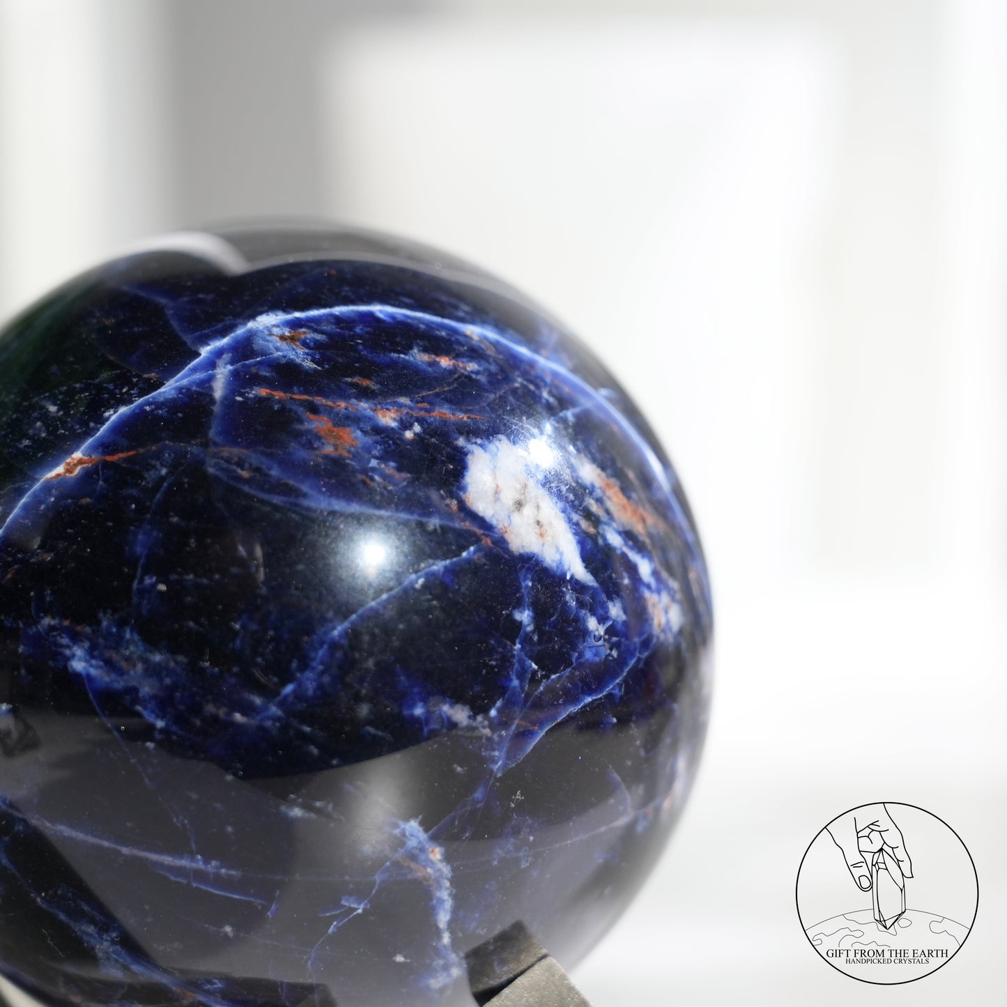 Larimar sphere with feldspar