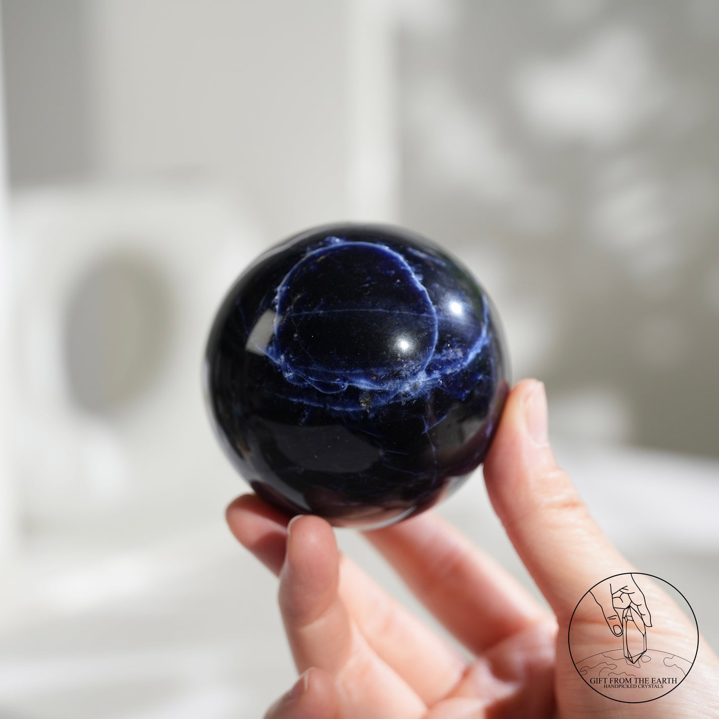 Larimar sphere with feldspar