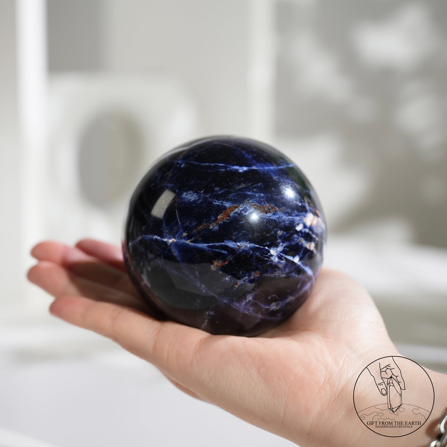 Larimar sphere with feldspar