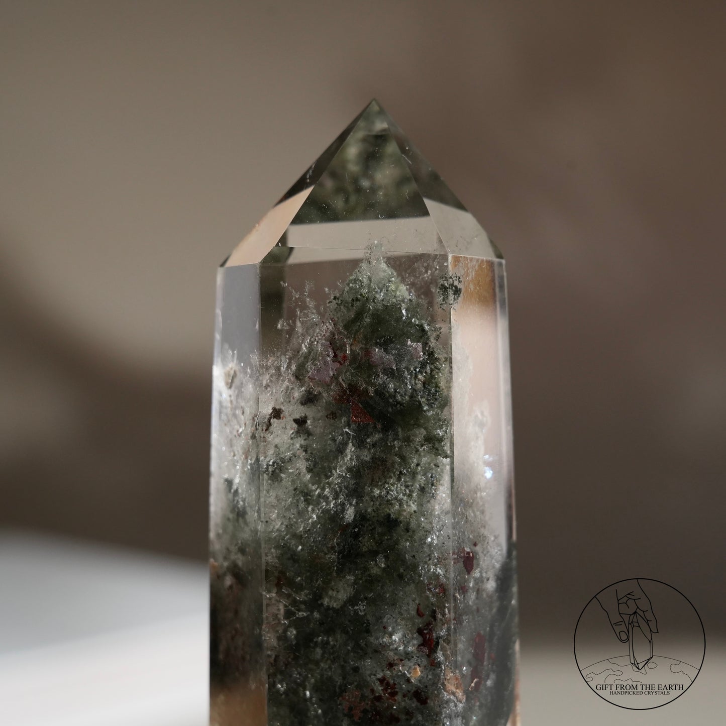 Half-polished multi-layered red-green phantom quartz point