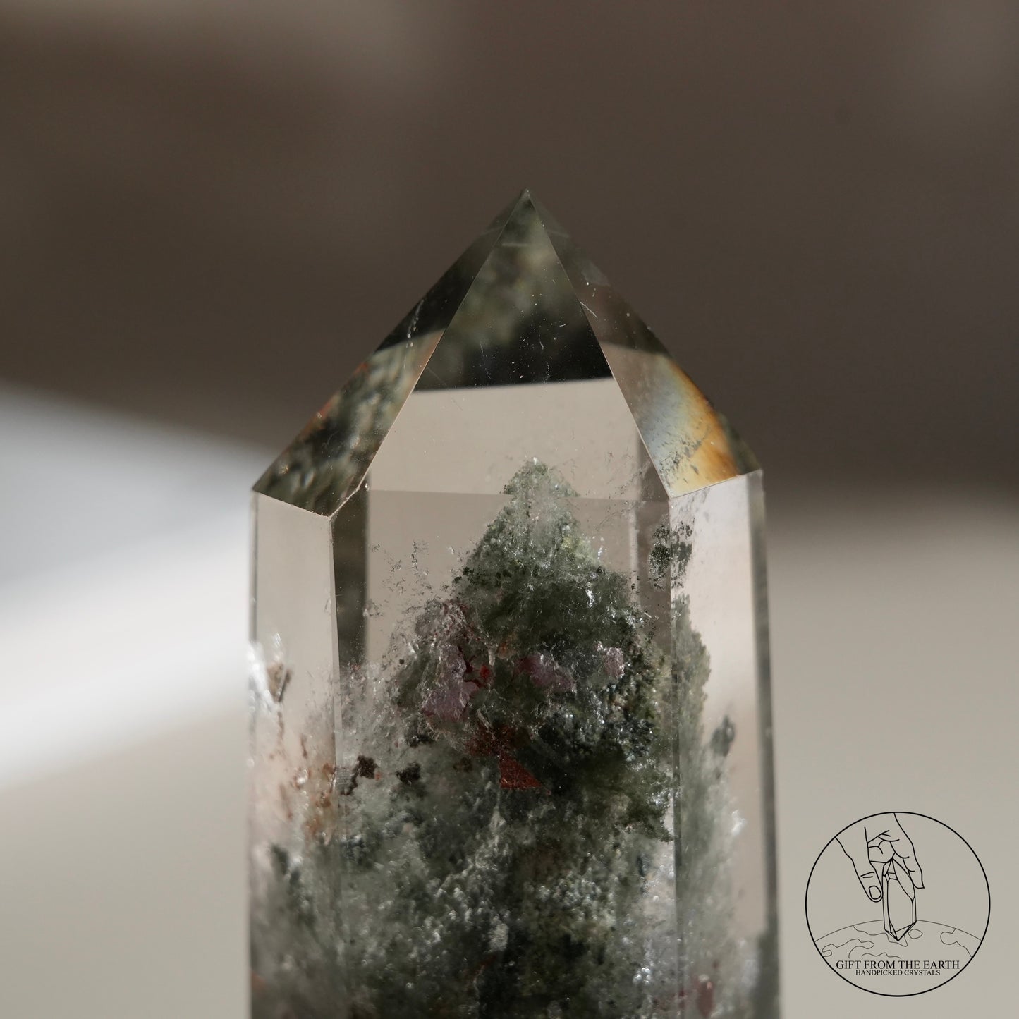 Half-polished multi-layered red-green phantom quartz point