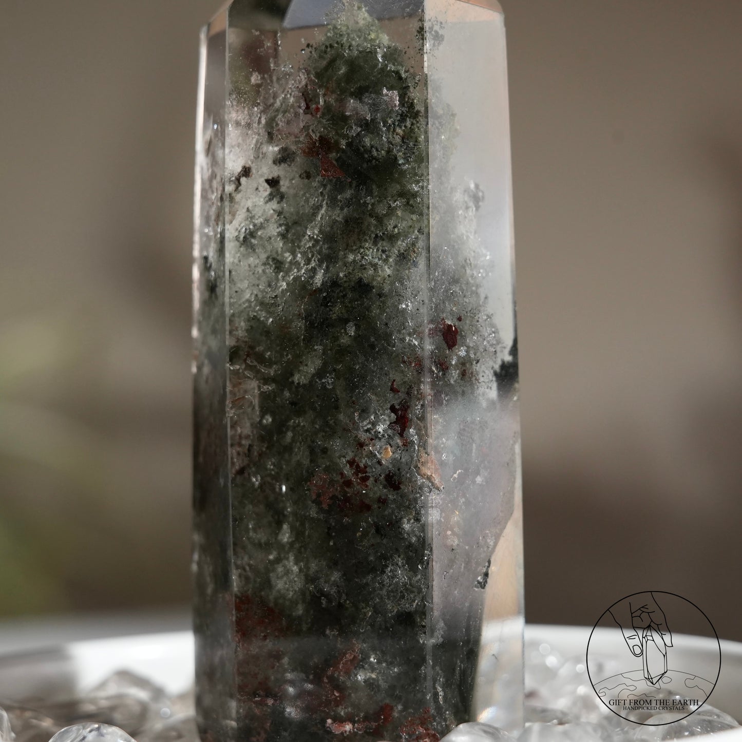 Half-polished multi-layered red-green phantom quartz point