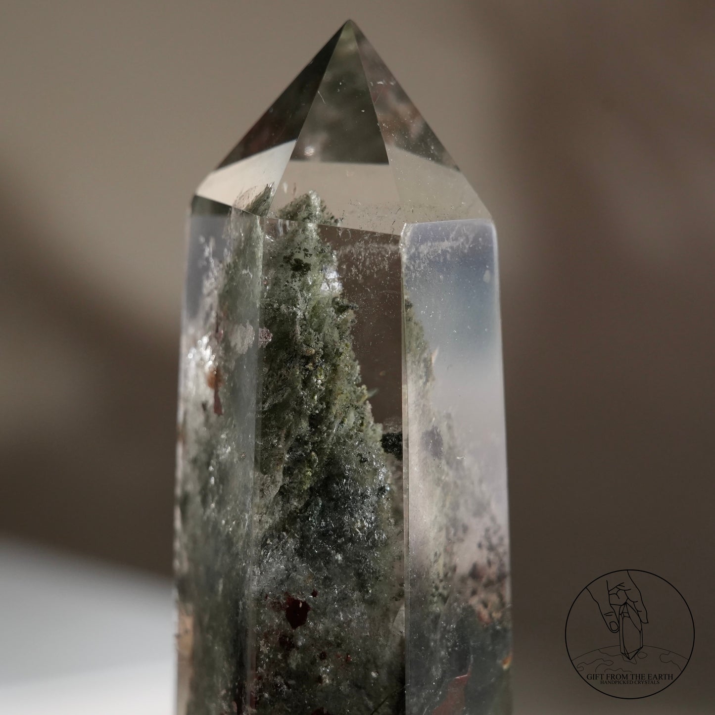 Half-polished multi-layered red-green phantom quartz point