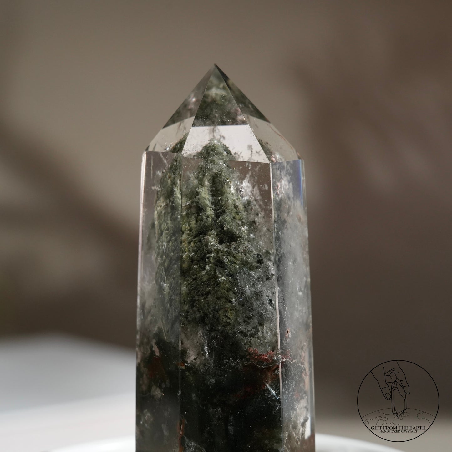 Half-polished multi-layered red-green phantom quartz point