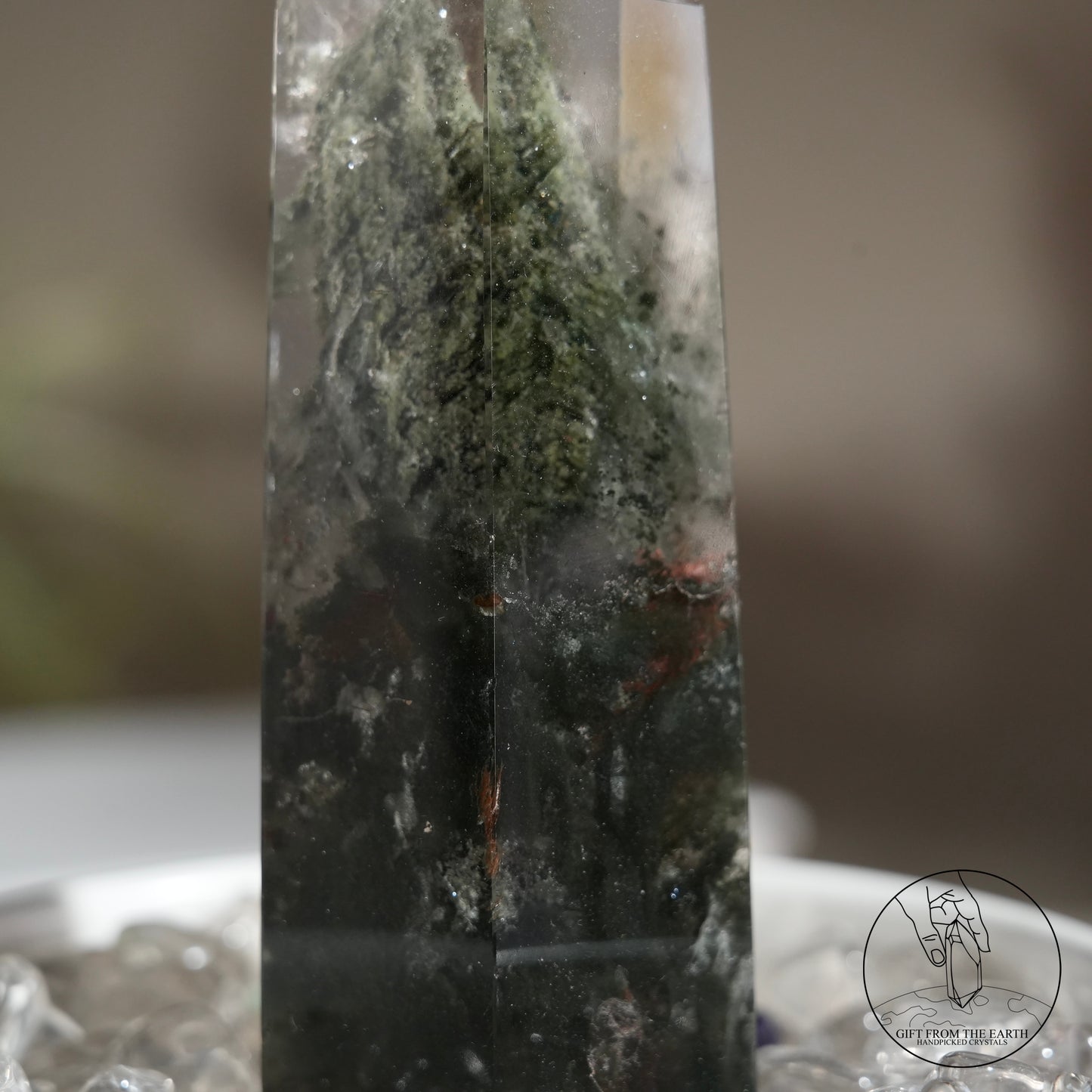 Half-polished multi-layered red-green phantom quartz point