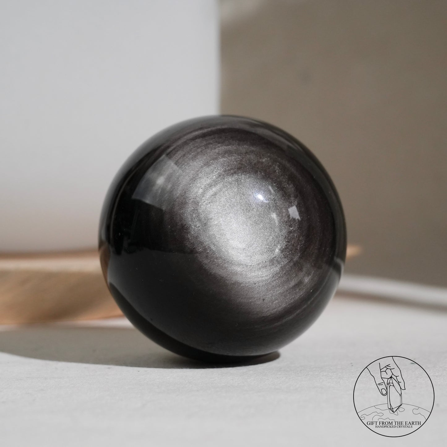 Silver sheen obsidian sphere