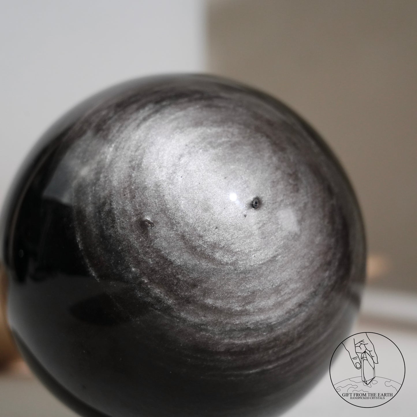 Silver sheen obsidian sphere