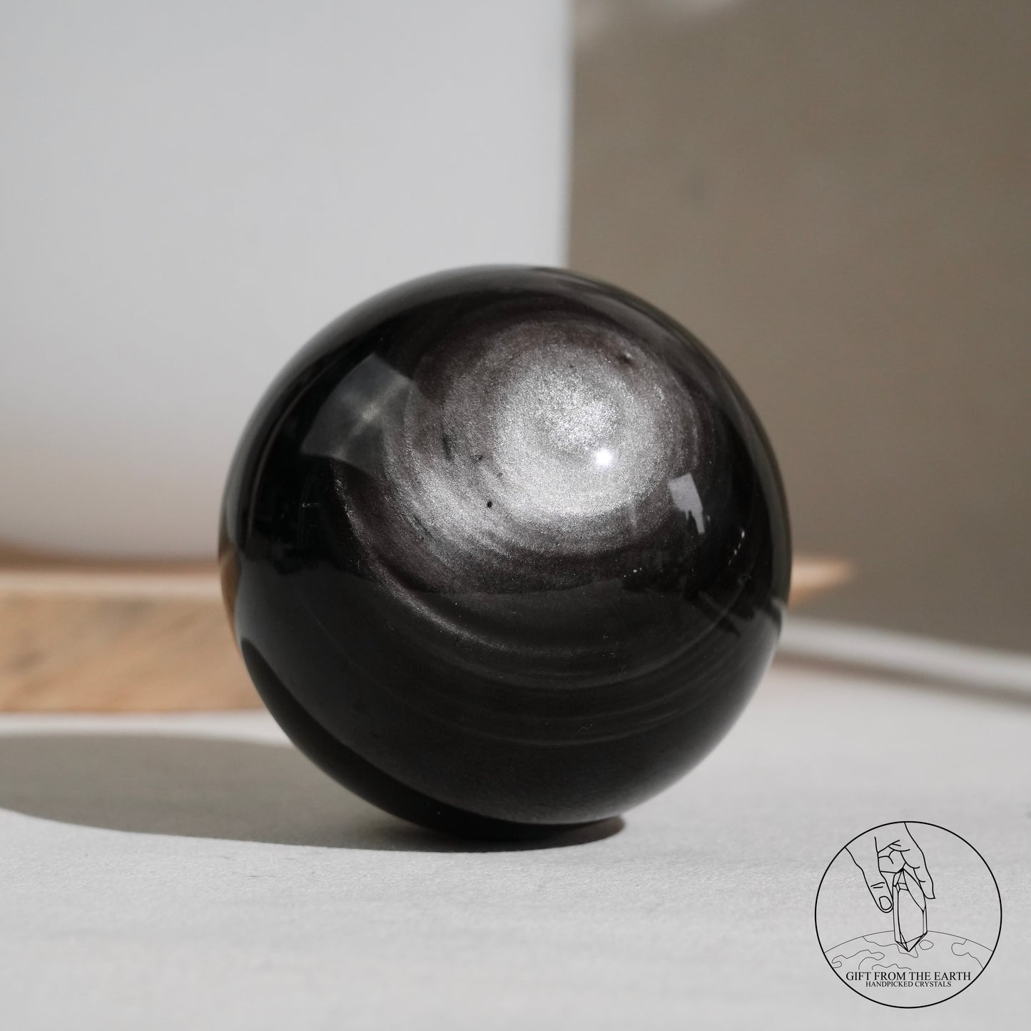 Silver sheen obsidian sphere