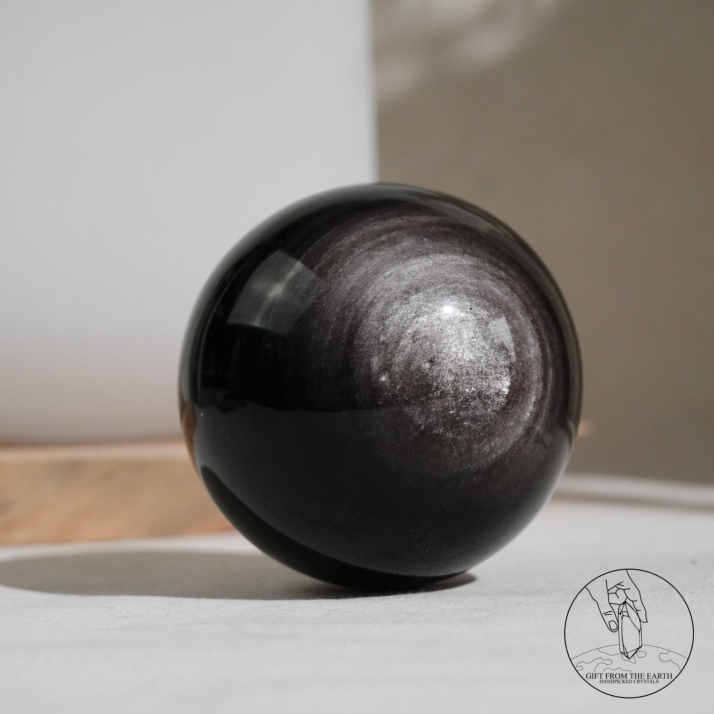 Silver sheen obsidian sphere