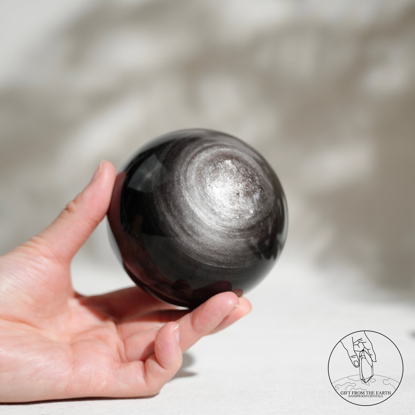 Silver sheen obsidian sphere