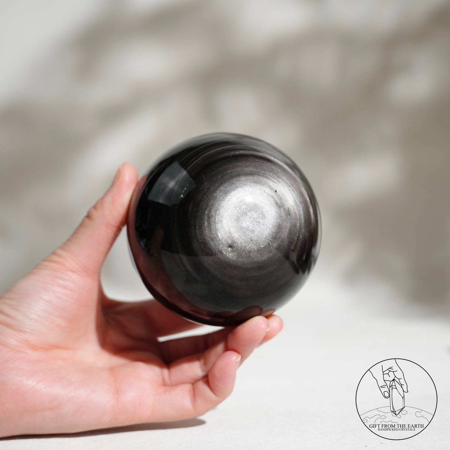Silver sheen obsidian sphere