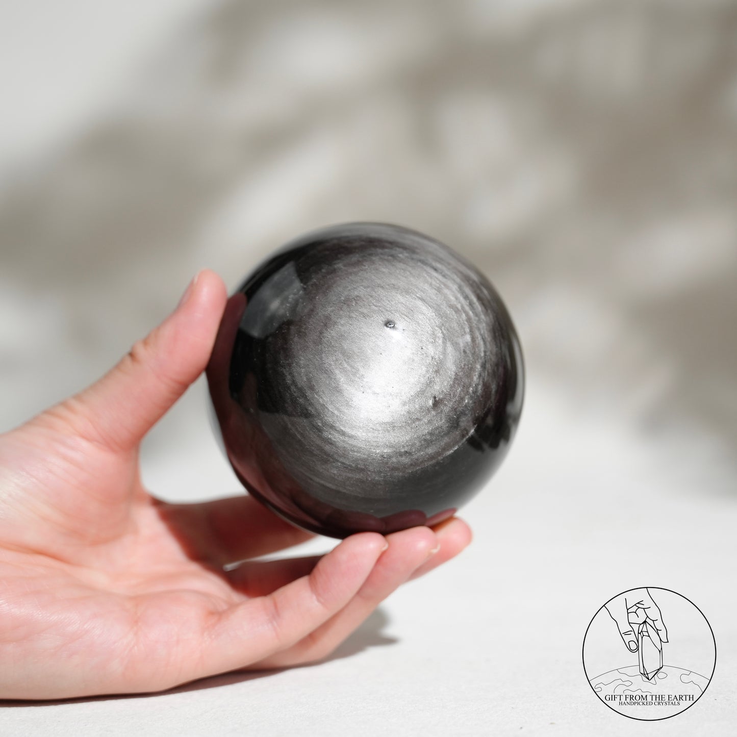 Silver sheen obsidian sphere