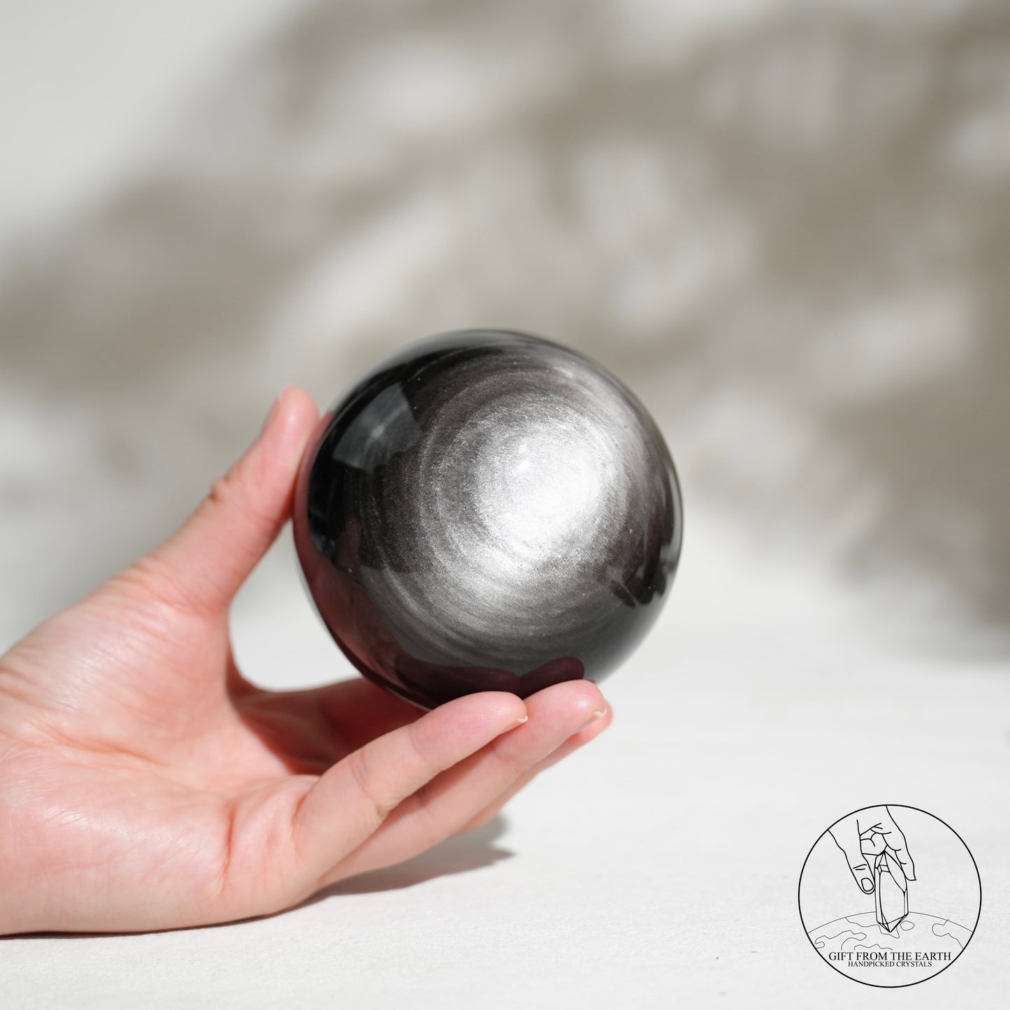 Silver sheen obsidian sphere