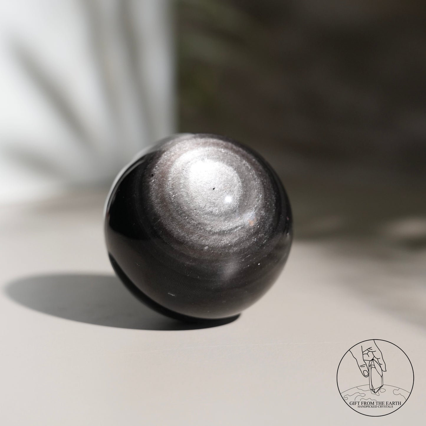 Silver sheen obsidian sphere