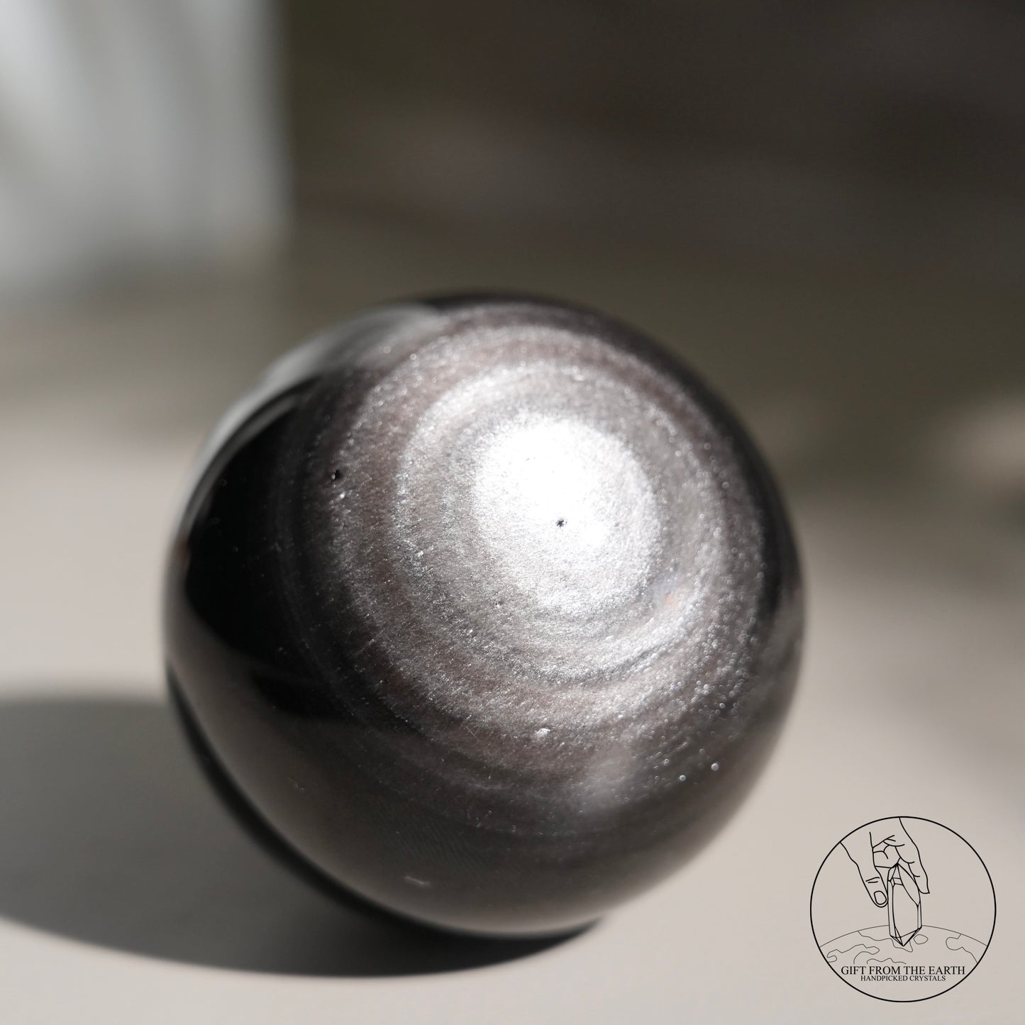 Silver sheen obsidian sphere