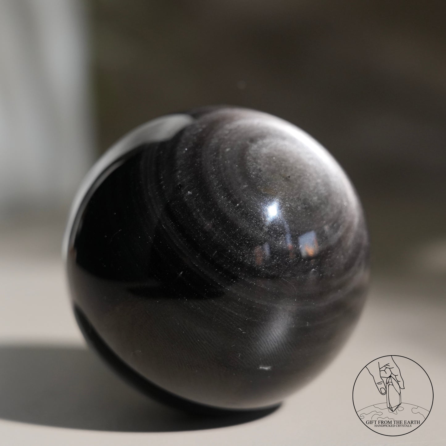 Silver sheen obsidian sphere