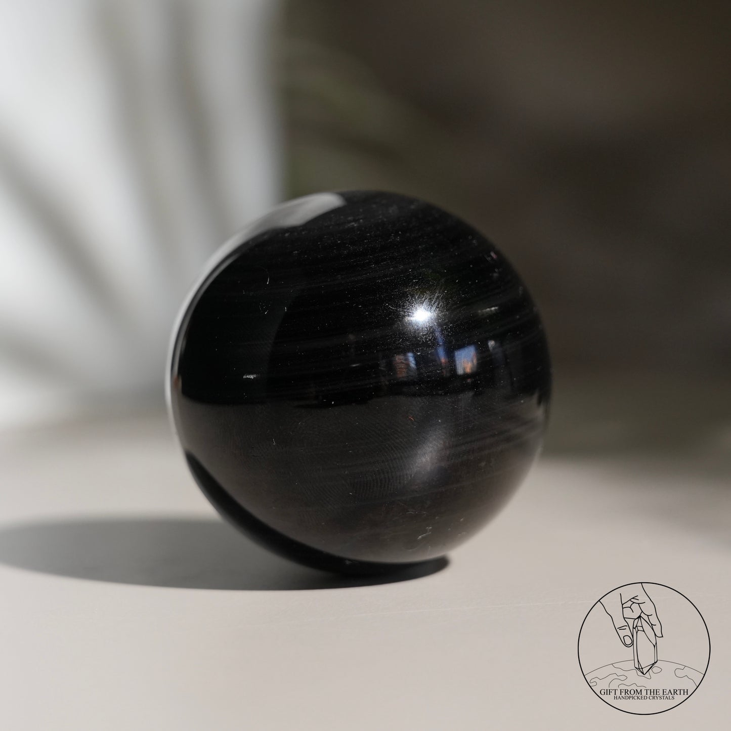 Silver sheen obsidian sphere