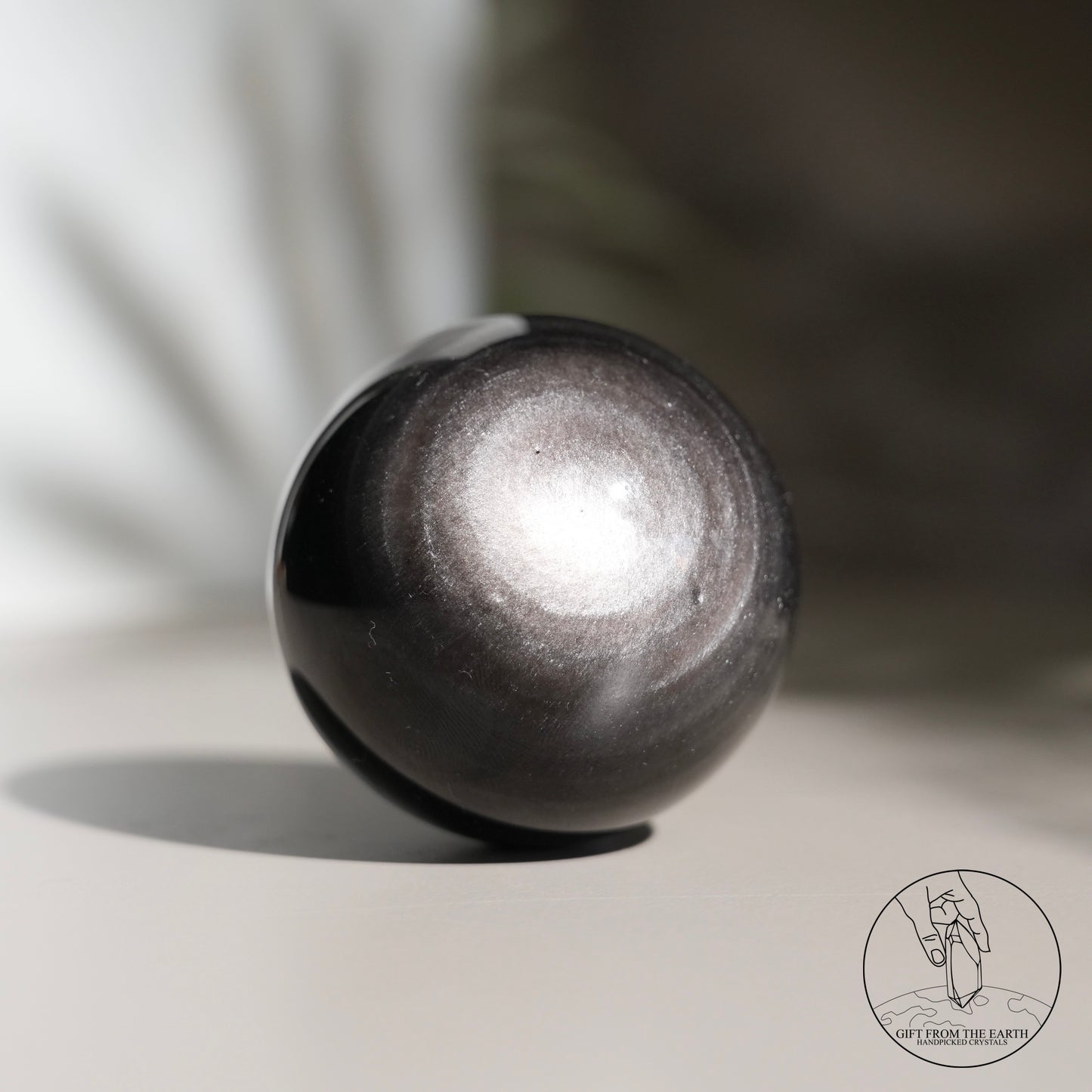 Silver sheen obsidian sphere