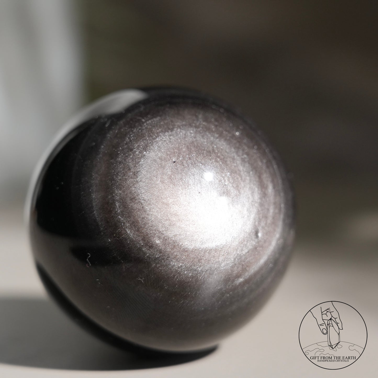 Silver sheen obsidian sphere