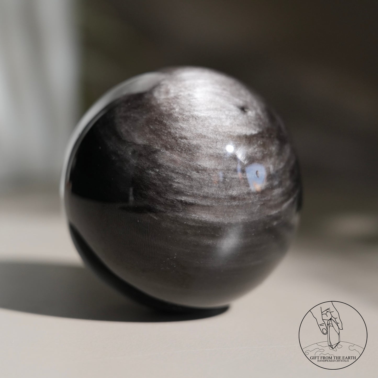 Silver sheen obsidian sphere