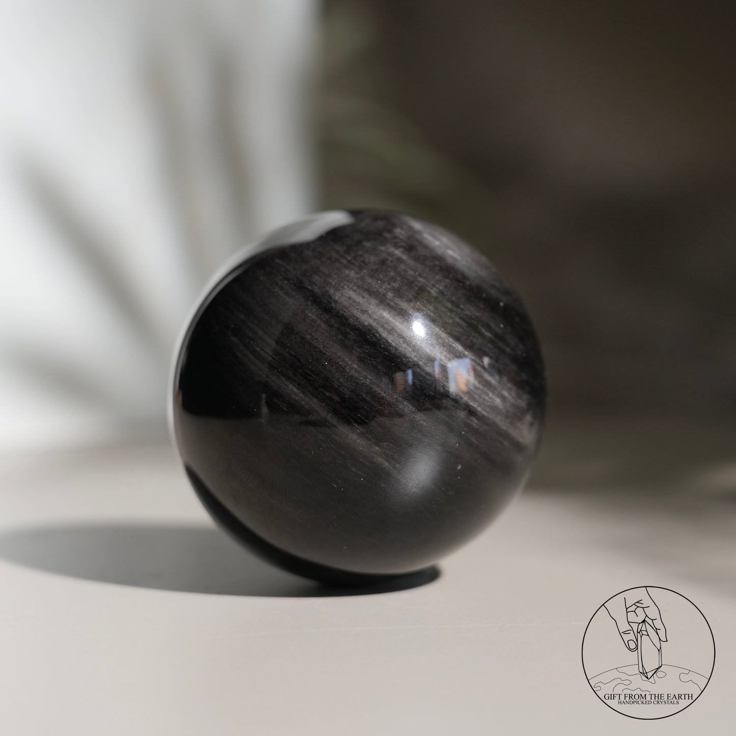 Silver sheen obsidian sphere