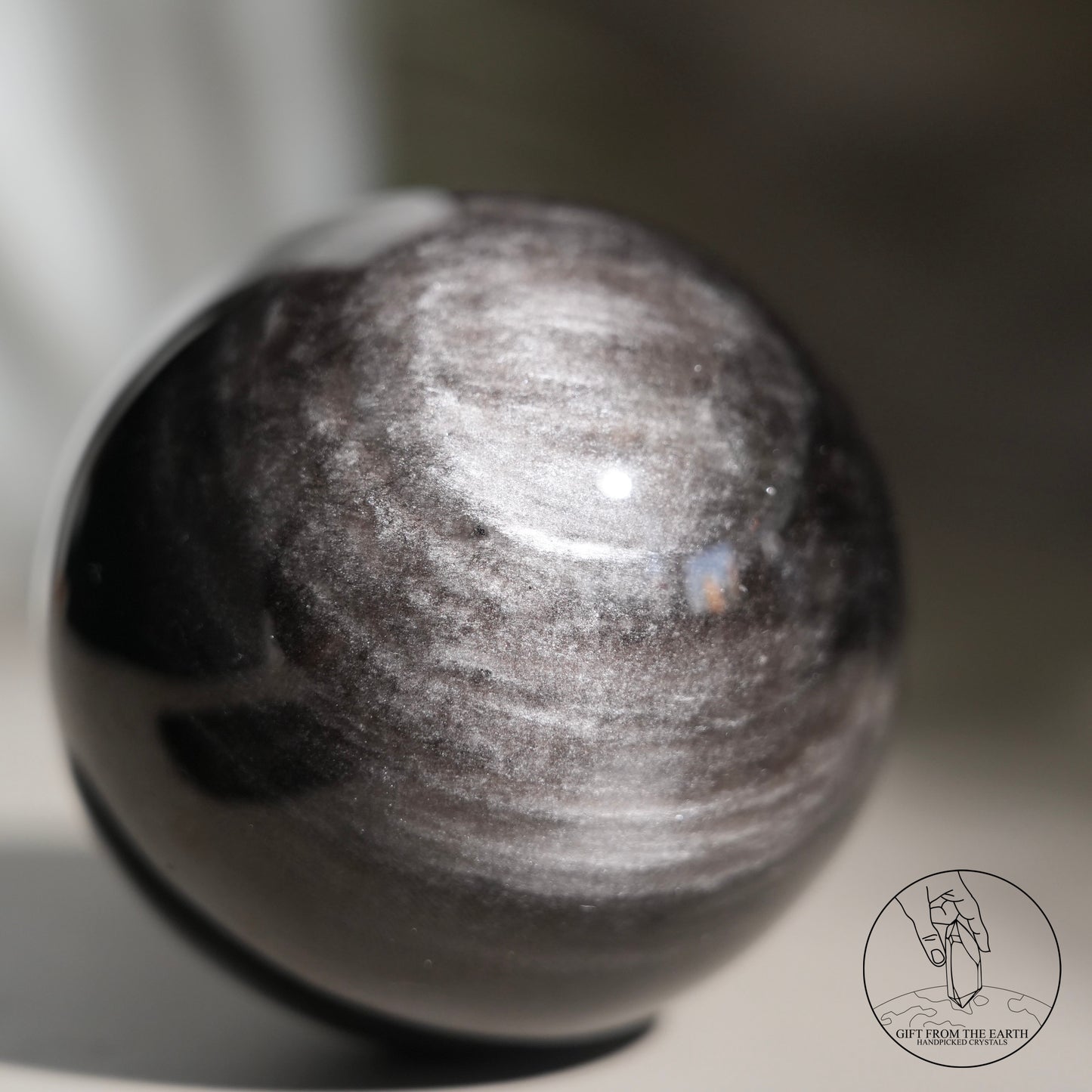 Silver sheen obsidian sphere