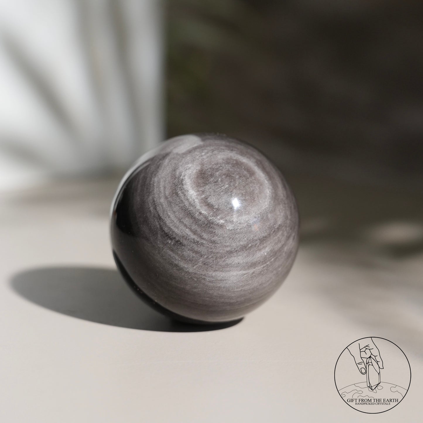 Silver sheen obsidian sphere