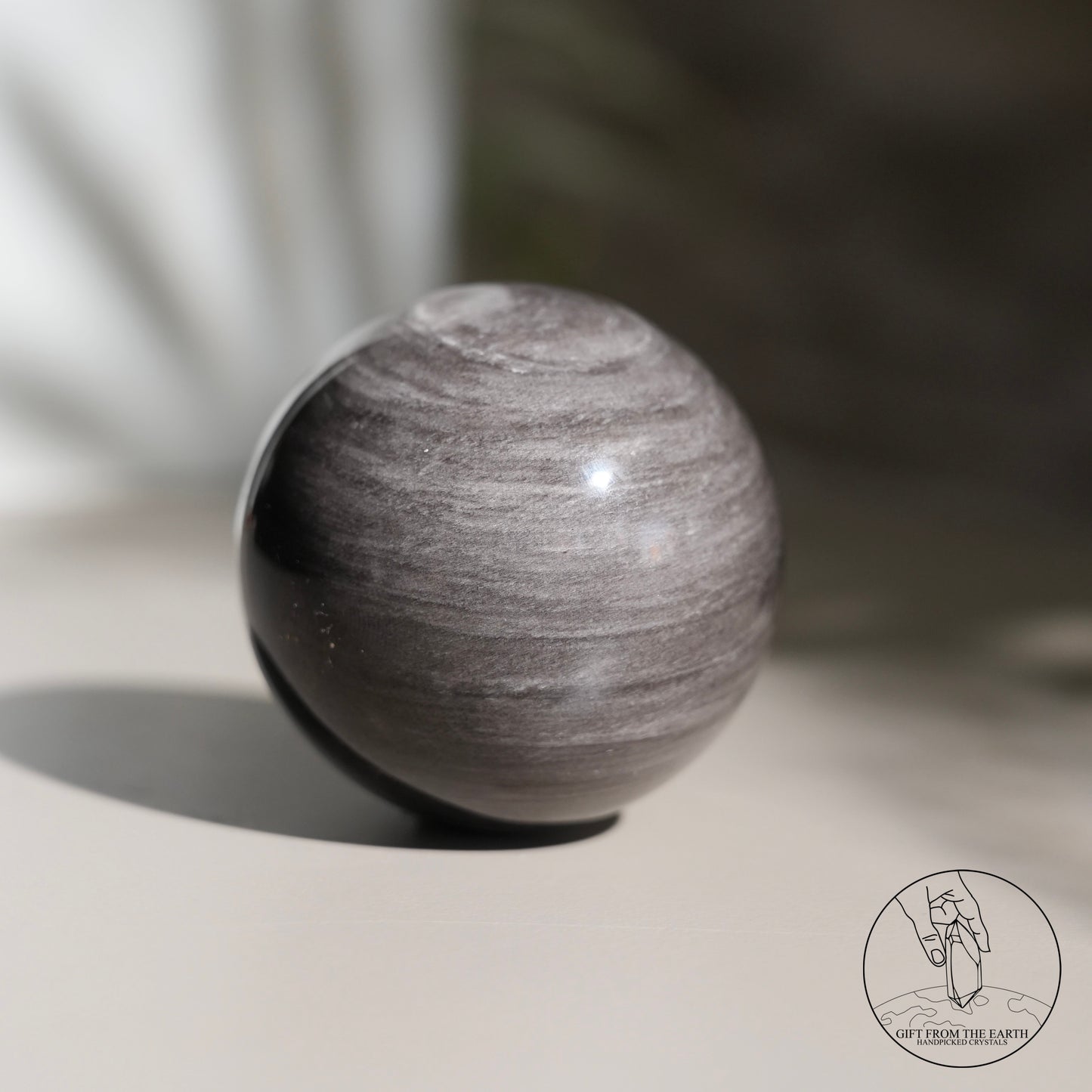 Silver sheen obsidian sphere