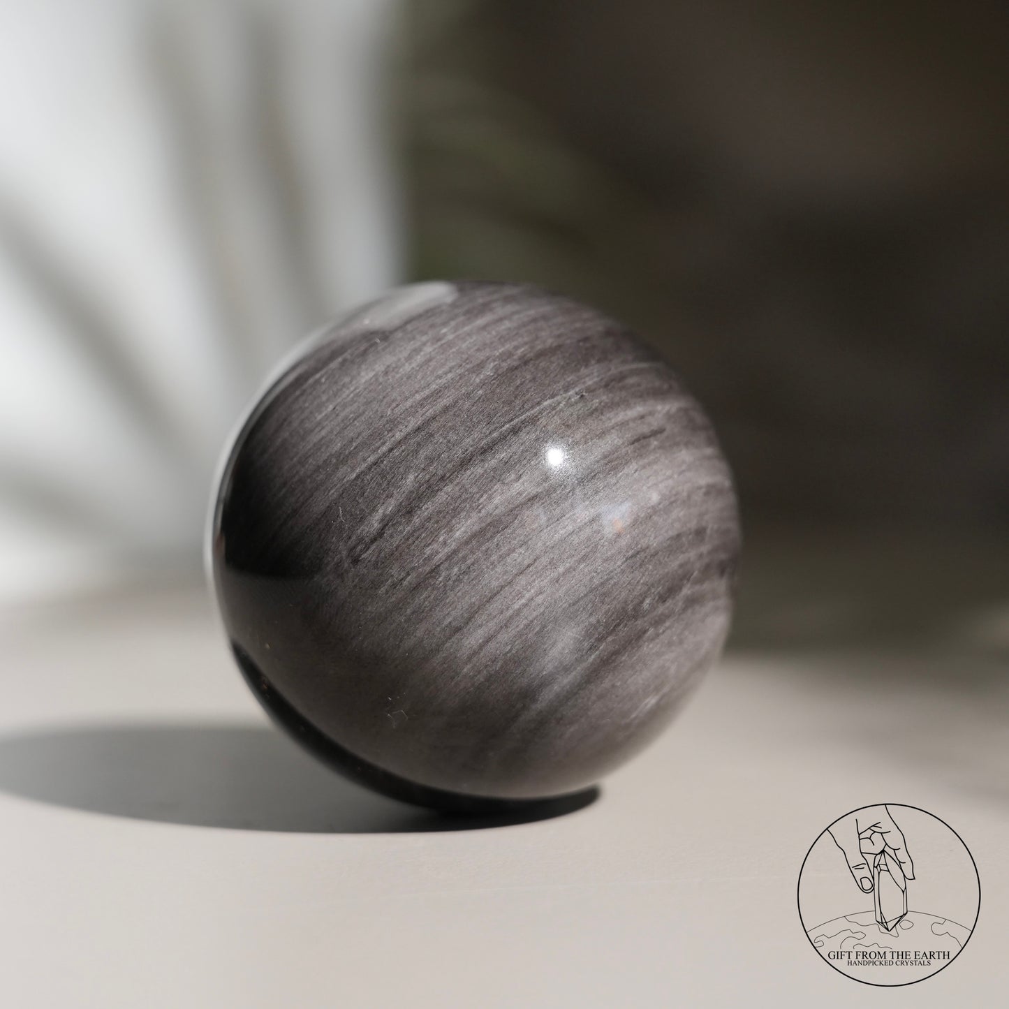 Silver sheen obsidian sphere