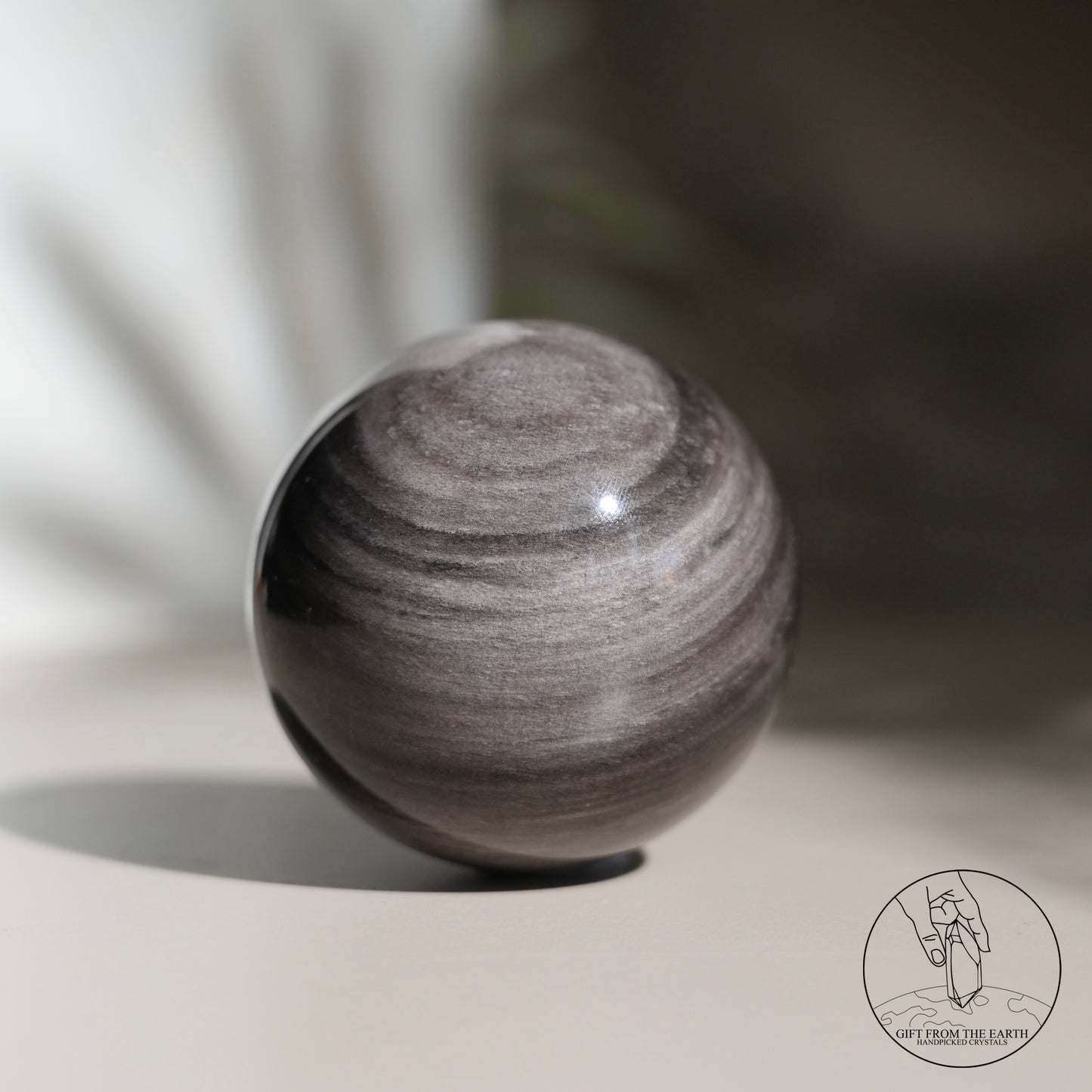 Silver sheen obsidian sphere