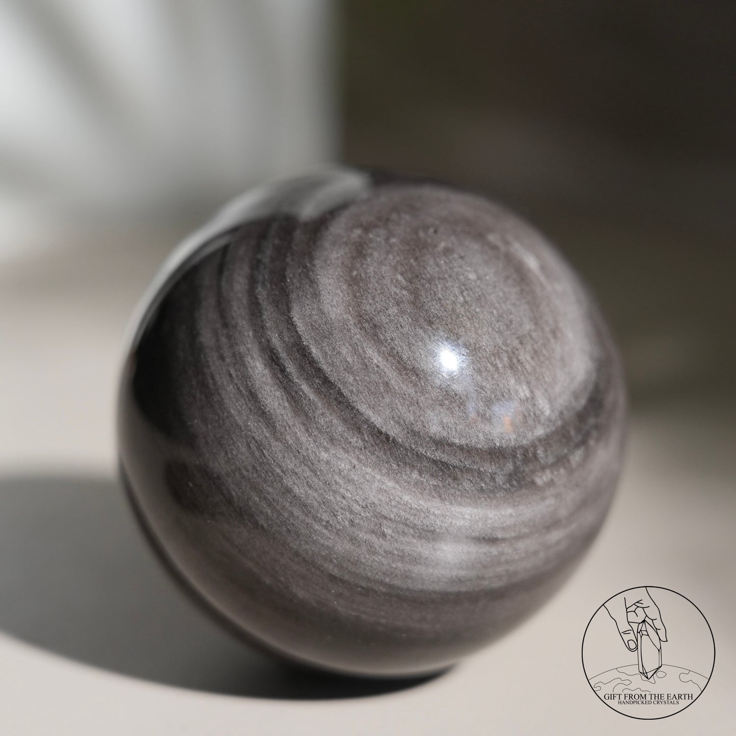 Silver sheen obsidian sphere