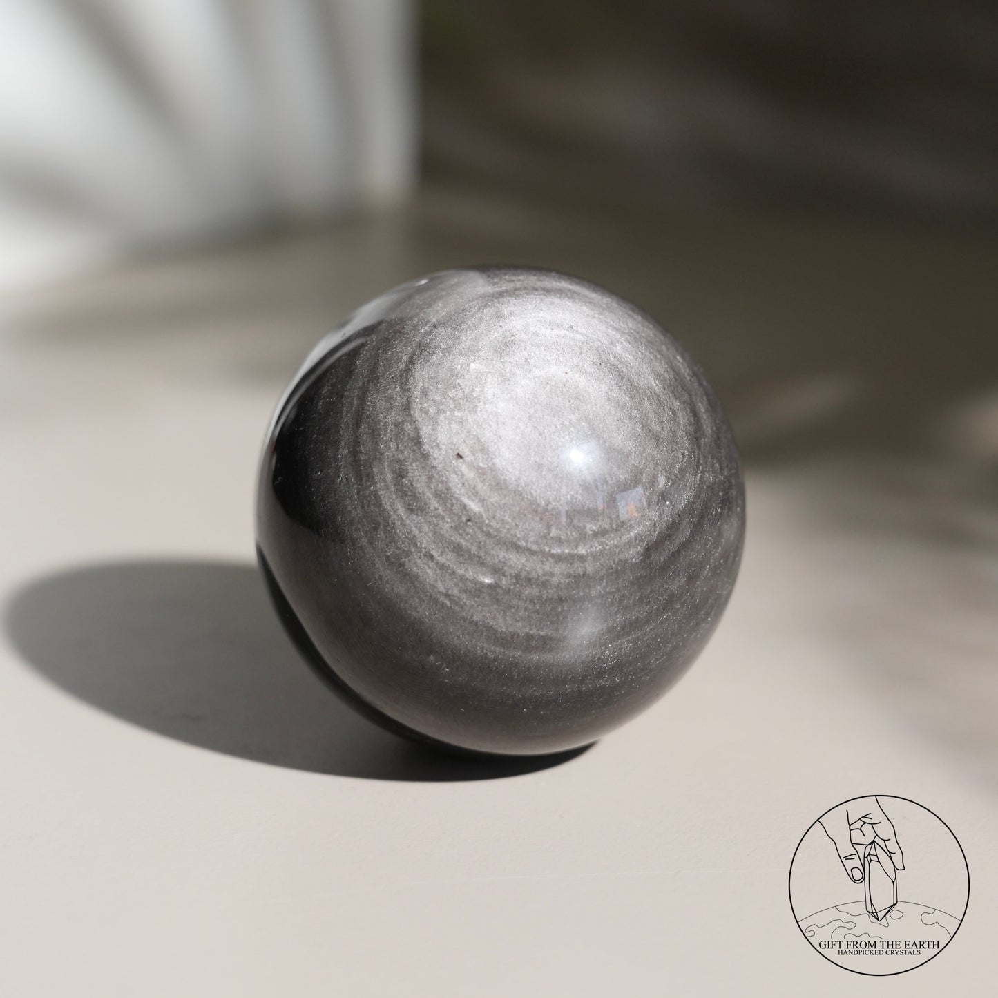 Silver sheen obsidian sphere