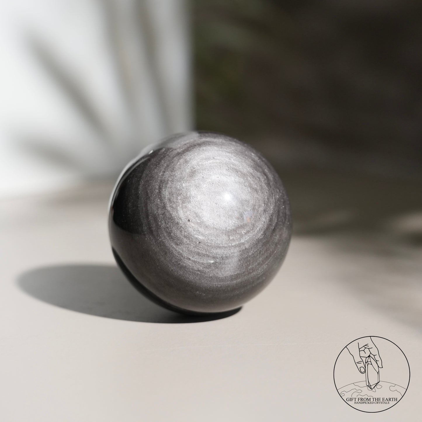 Silver sheen obsidian sphere