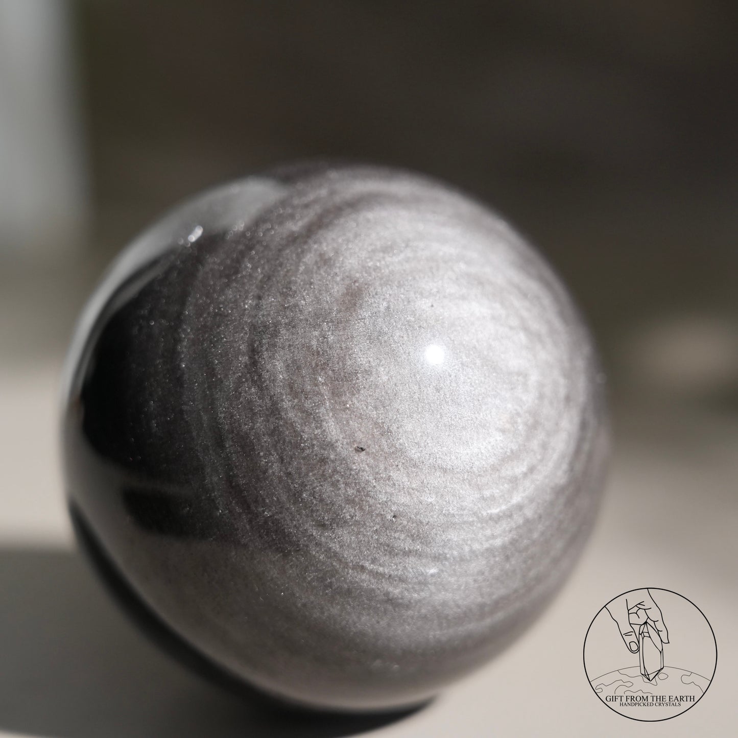 Silver sheen obsidian sphere